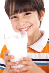 boy drinking milk in glass